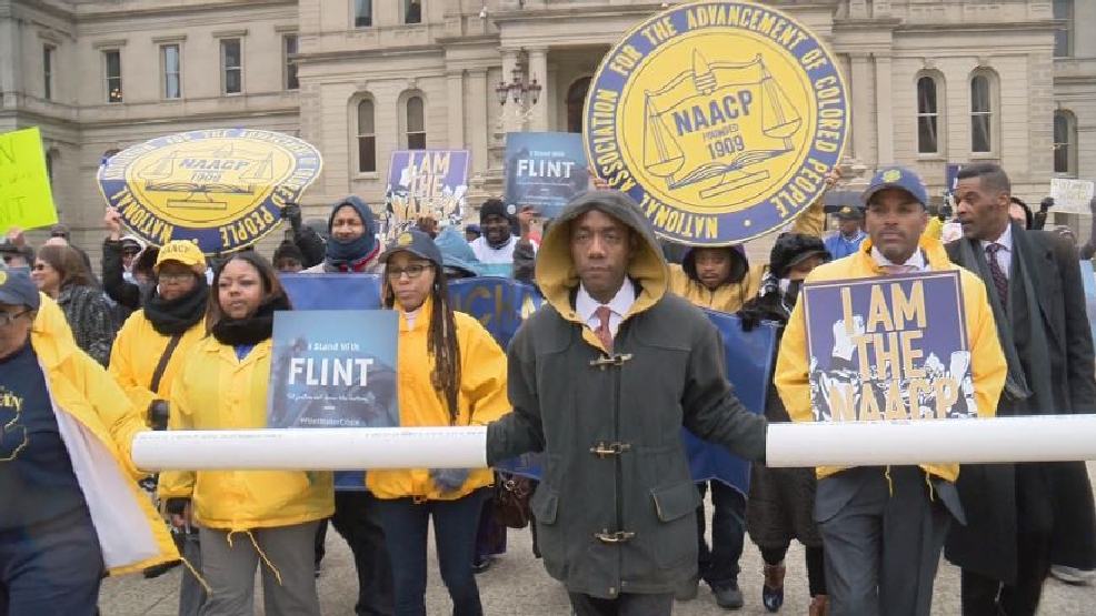 NAACP water crisis protestors block street in Lansing WEYI