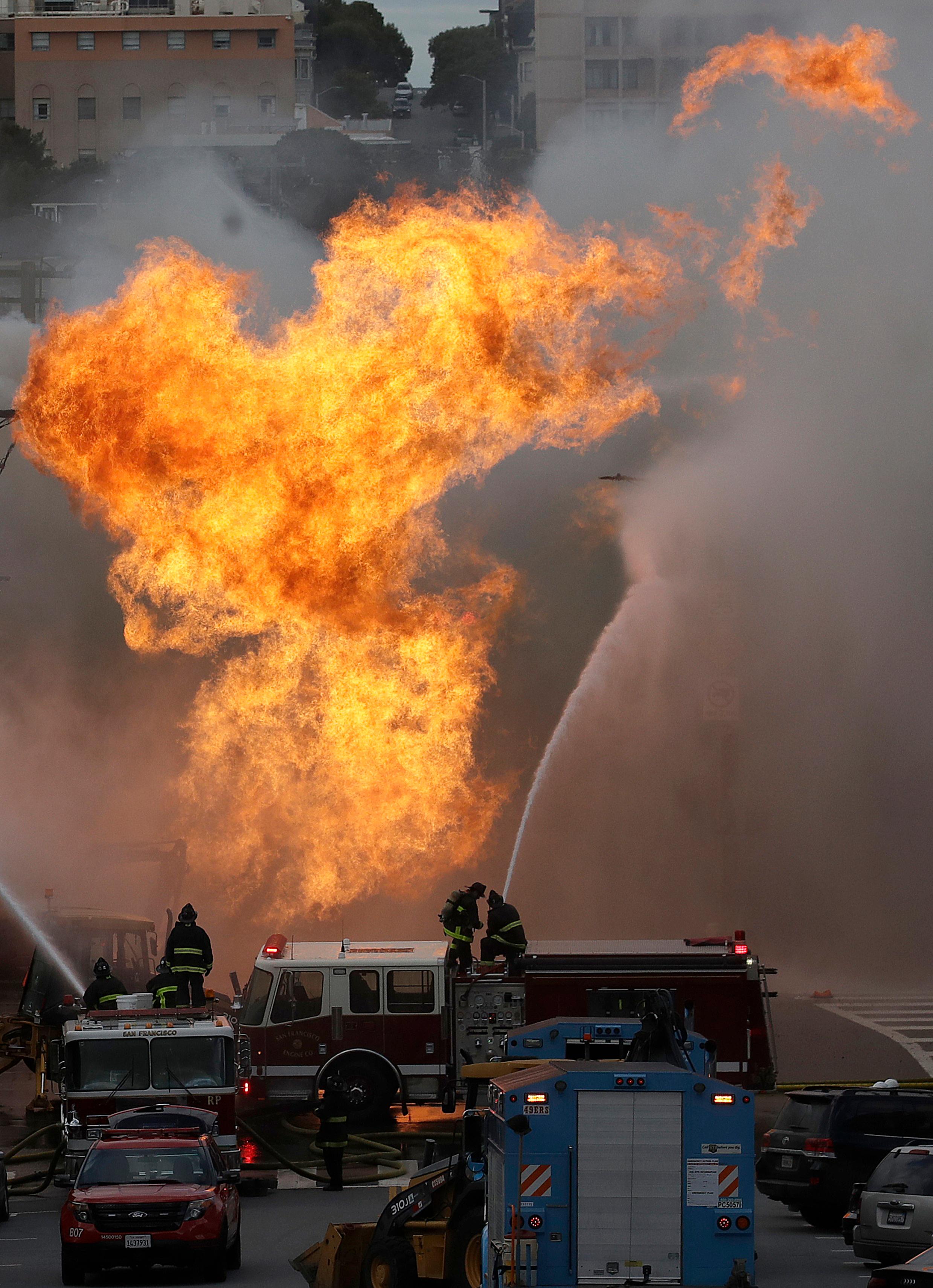 san francisco firefighters battle a fire on geary boulevard in